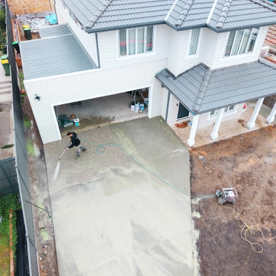 Aerial view of a driveway being washed at a two-storey home